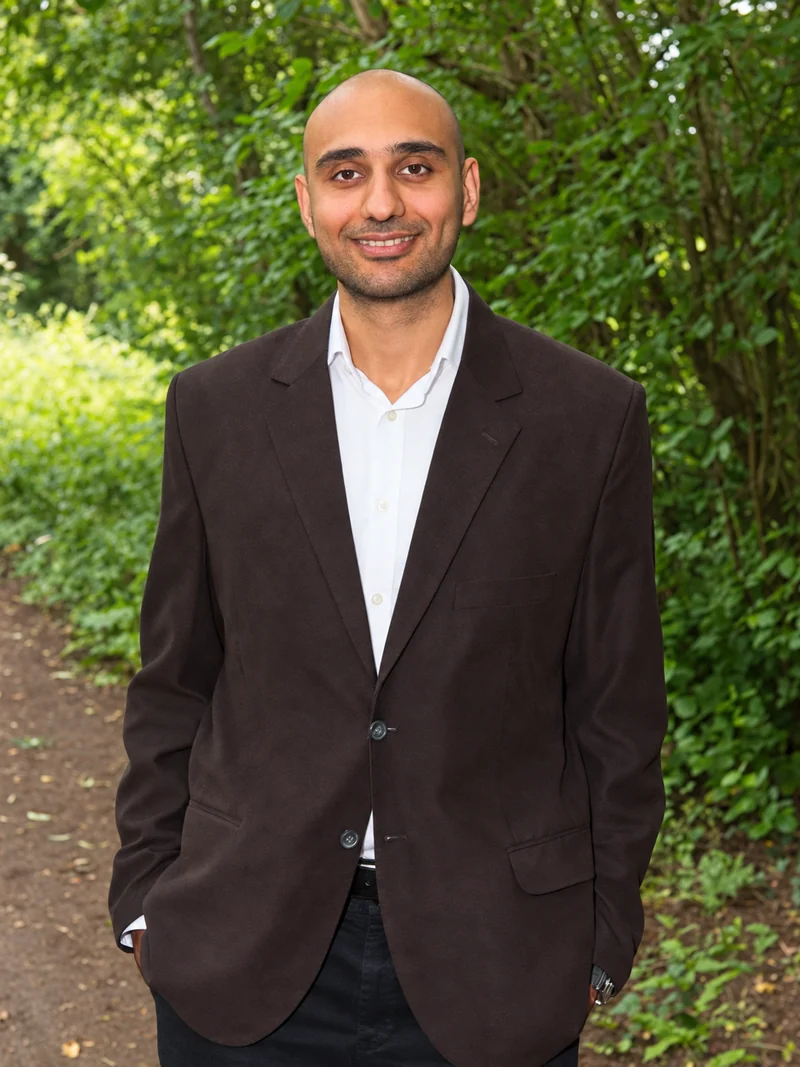 Adel Moin, hypnotherapist in Rugby, standing outdoors with trees in the background