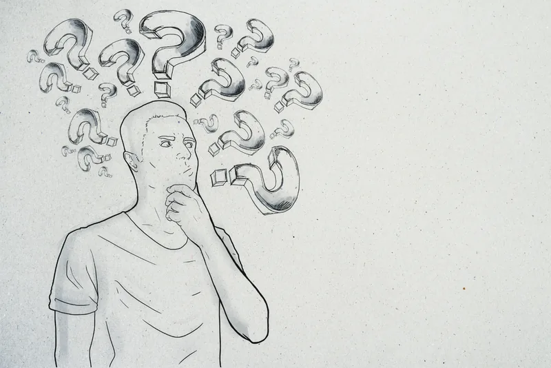 A drawing of a person surrounded by question marks
