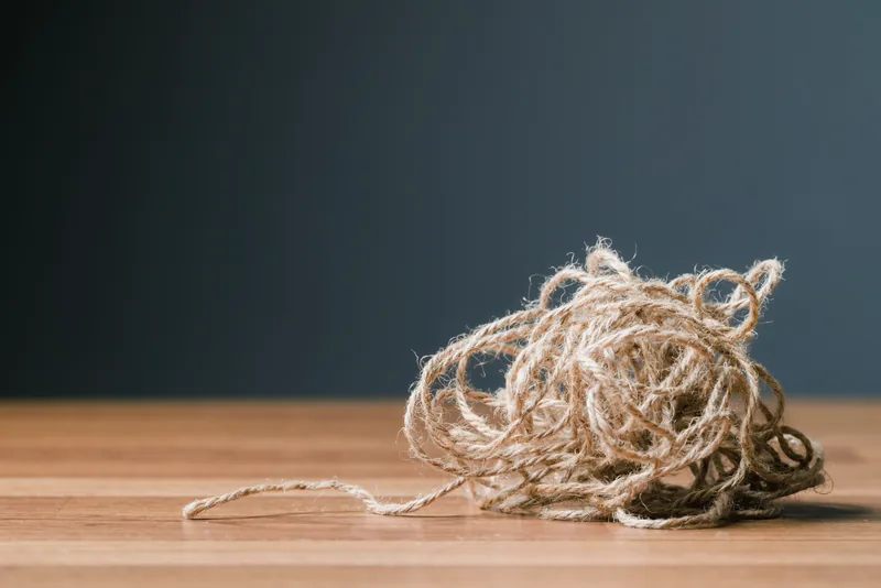 Tangled twine on a wooden table